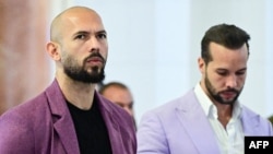 Andrew Tate (left) and his brother, Tristan Tate, outside an appeals court in Bucharest on December 10. 