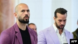 Andrew Tate (left) and his brother, Tristan Tate, outside an appeals court in Bucharest on December 10. 