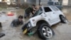 Japan-Residents try to upright a vehicle stuck in a flood hit area in Kurashiki, Okayama prefecture on July 9, 2018. Rescue workers, police and troops in Japan battled on July 9 to reach people feared trapped by devastating flooding and landslides after d