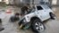 Japan-Residents try to upright a vehicle stuck in a flood hit area in Kurashiki, Okayama prefecture on July 9, 2018. Rescue workers, police and troops in Japan battled on July 9 to reach people feared trapped by devastating flooding and landslides after d