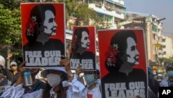 Anti-coup protesters display pictures of the deposed leader of Burma, Aung San Suu Kyi. (file photo)