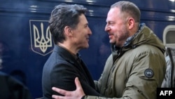 Canadian Prime Minister Justin Trudeau (left) is greeted at the Kyiv train station on February 24 by the head of the Office of the President of Ukraine, Andriy Yermak.