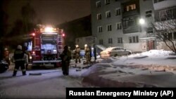 Firefighters work at the site of the fire in Yekaterinburg on January 12.