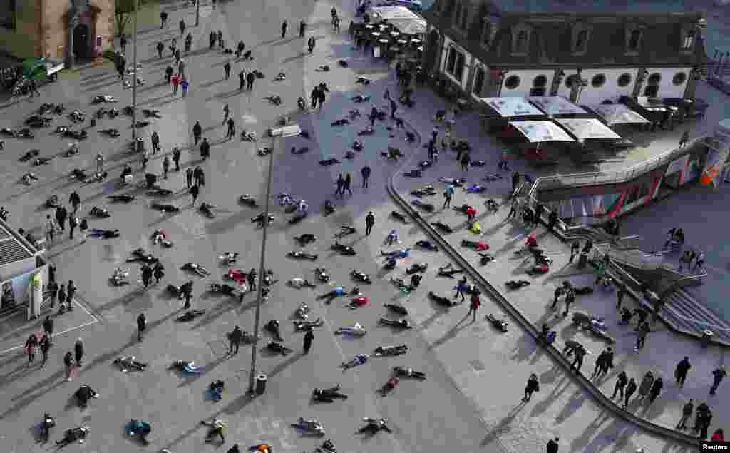 People lie down in a pedestrian zone of Frankfurt on March 24 as part of an art project in remembrance of the 528 victims of the Katzbach Nazi concentration camp. (Reuters/Kai Pfaffenbach)