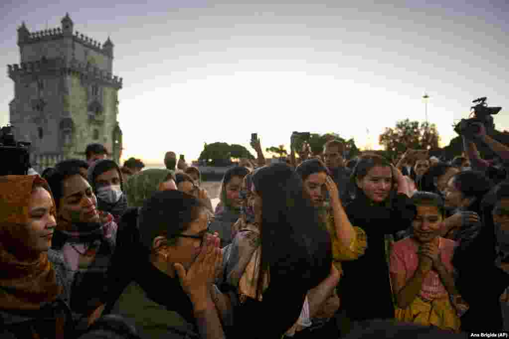 Captain Farkhunda Muhtaj (center) hugs a team member as they meet at a park by the Tagus River in Lisbon on September 29.