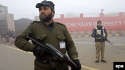 Pakistani security officials stand guard outside Bacha Khan University, in Charsadda, on January 25.