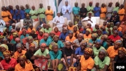 Some newly released Chibok girls meet with Nigerian President Muhammadu Buhari (center) in Abuja on May 7. 