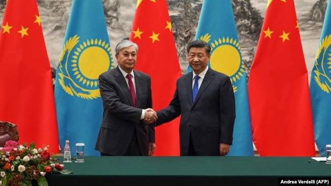 Chinese President Xi Jinping (right) shakes hands with Kazakh President Qasym-Zhomart Toqaev at a ceremony at the Great Hall of the People in Beijing in 2019.