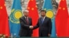 Chinese President Xi Jinping (right) shakes hands with Kazakh President Qasym-Zhomart Toqaev at the end of a signing ceremony at the Great Hall of the People in Beijing on September 11, 2019.