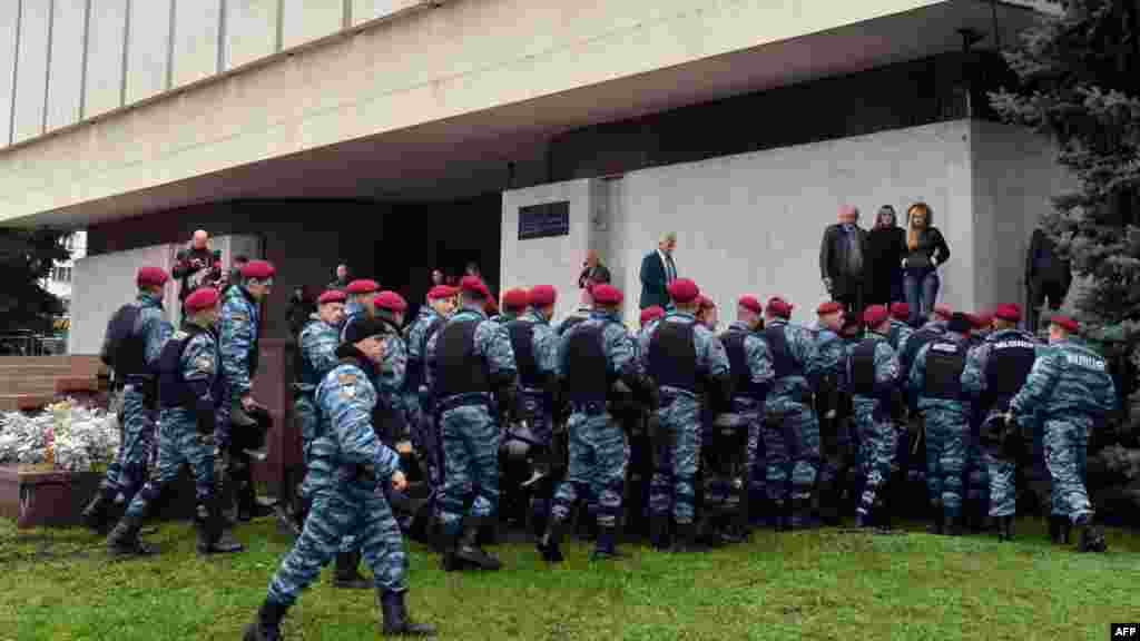 Riot police keep watch during the protest.