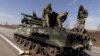 UKRAINE – A Ukrainian soldier sits on top of a Russian artillery vehicle marked with the 'Z' symbol, which Ukraine captured during fighting outside Kharkiv, as Russia's attack on Ukraine continues, March 29, 2022