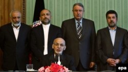 Standing behind Afghan President Ashraf Ghani, intelligence chief Rahmatullah Nabil and acting Defense Minister Masoon Stanekzai are part of the delegation going to Pakistan.