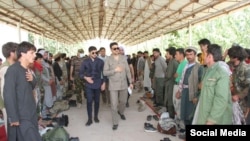 The Afghan ambassador to Tajikistan, Mohammad Zahir Aghbar, meets with Afghan refugees in the Tajik border city of Khorugh in early July.