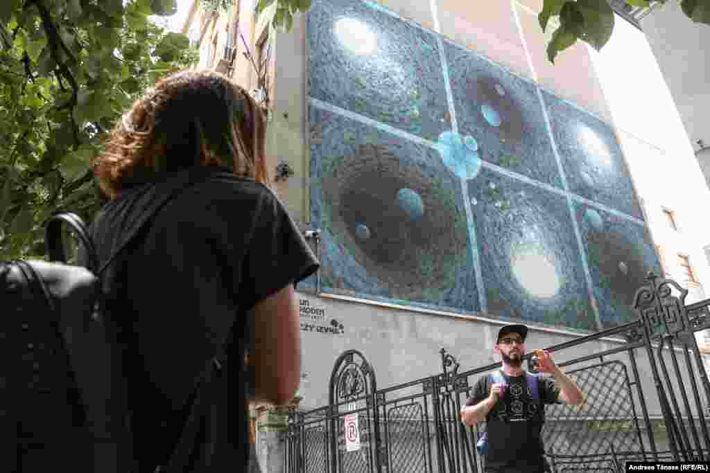 Street art by iZZY iZVNE and Bboy Vean on the side of the Faculty of Sociology and Social Work in Bucharest. The style is called Space Calligraphy, with the six spirals representing poems written by Ancuta Clim, Alexandra M. Paun, and Vasile Leac.