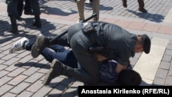 Police detain a gay rights activist during an unauthorized rally in Moscow back in May. 