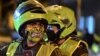 Police officers use face masks as a preventive measure against the spread of the new coronavirus, COVID-19, in Cali, Colombia on March 20, 2020.