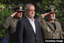 Iranian President Masud Pezeshkian (center)