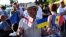 A man holds flags of the European Union, Georgia, Ukraine, and Moldova at a rally in support of Georgia's EU membership bid in central Tbilisi on June 16.