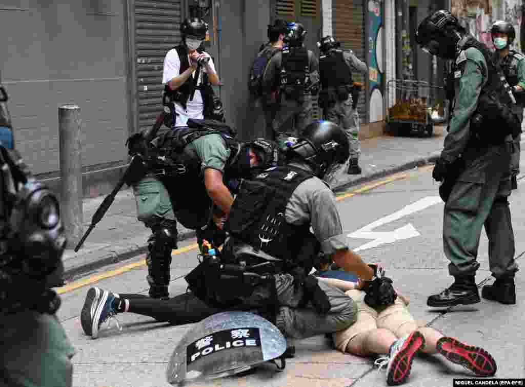 Policia në Hong Kong në korrik të vitit 2020, teksa arreston një person gjatë protestave kundër një ligji të ri për sigurinë. (EPA-EFE/MIGUEL CANDELA)