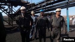 Miners gather outside after a gas explosion at a coal mine in Iran's South Khorasan Province on September 22.