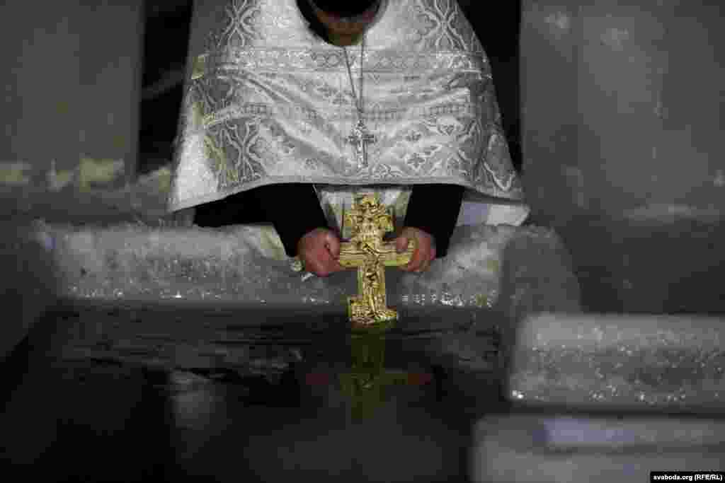 A priest blesses the water in Minsk, Belarus.