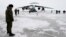A Russian officer stands near a military cargo plane near Nagurskoye, Russia's northernmost military outpost.