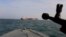 A speedboat from Iran's Revolutionary Guards Corps trains a weapon toward the British-flagged oil tanker Stena Impero, which was seized in the Strait of Hormuz on July 19. 