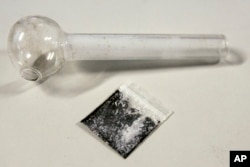 A pouch containing crystalized methamphetamine and a homemade pipe. (file photo)