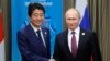 Putin, Abe Vow To Seek WWII Treaty, Solution To Island Dispute