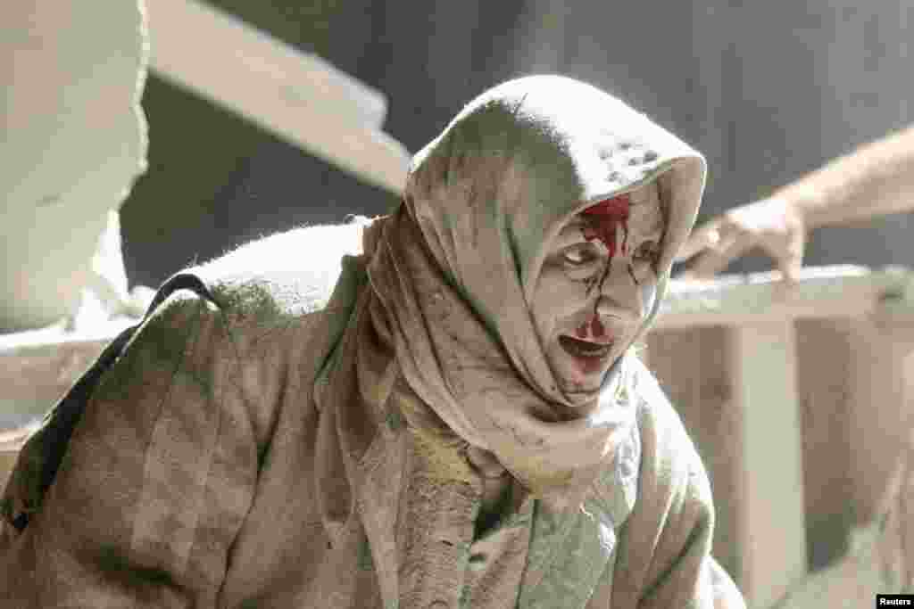 An injured woman reacts at a site hit by air strikes in the rebel-held area of Old Aleppo, Syria. (Reuters/Abdalrhman Ismail)