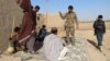 Afghan Local Police officers stand at a checkpoint in Helmand.