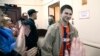 Relatives and supporters applaud as Ukrainian sailors are escorted by Russian FSB officers to the courtroom in Moscow on April 17.