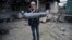 NAGORNO-KARABAKH - A man shows a shell fragment in the yard of his brother's house damaged by shelling during fighting between Armenia and Azerbaijan over the breakaway Nagorno-Karabakh region, in the disputed region's city of Martuni , October 1, 2020