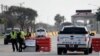 US — Police officers stand at a checkpoint after a shooting incident at Naval Air Station Corpus Christi, 21may2020