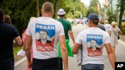 Viktor Orbán a fost întâmpinat de zeci de susținători care au venit la Băile Tușnad cu tricouri personalizate cu o parafrază din sloganul lui Donald Trump, MAGA (Make America Great Again), în care Great (mare) a fost înlocuit cu Ungaria pentru a sugera măreția Ungariei.