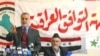 Adnan al-Dulaymi (seated) at a previous press conference