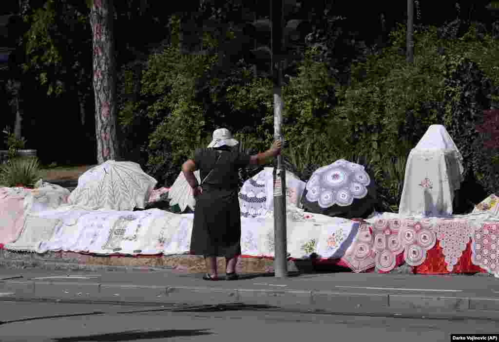 A street vendor sells handmade crochet at an entrance to Veliki Kalemegdan Park in Belgrade.