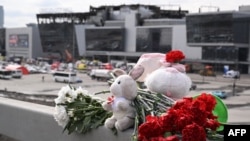 Flowers and toys are seen left at the side of a road near the burned-out Crocus City Hall concert venue in Krasnogorsk, outside Moscow, on March 26.