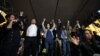 Officials, including Estonian Foreign Minister Margus Tsahkna, Icelandic Foreign Minister Thordis Kolbrun Reykfjörd Gylfadottir and Lithuanian Foreign Minister Gabrielius Landsbergis, together raise their hands as they join protesters rallying against the