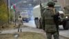 Azerbaijani military trucks move through the town of Lachin on December 1.