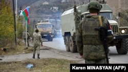 Azerbaijani military trucks move through the town of Lachin on December 1.