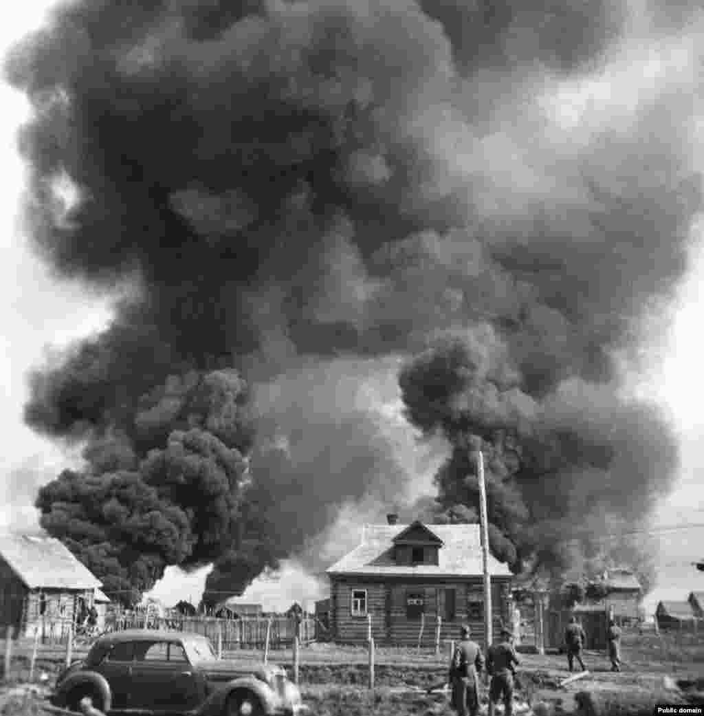 German soldiers watch a Soviet village burn in June 1941. &nbsp; Barbarossa was the largest military ground invasion in history, with some 3.8 million troops, thousands of tanks and aircraft, and more than half a million horses advancing across the entirety of Eastern Europe, from the Gulf of Finland to the Black Sea.