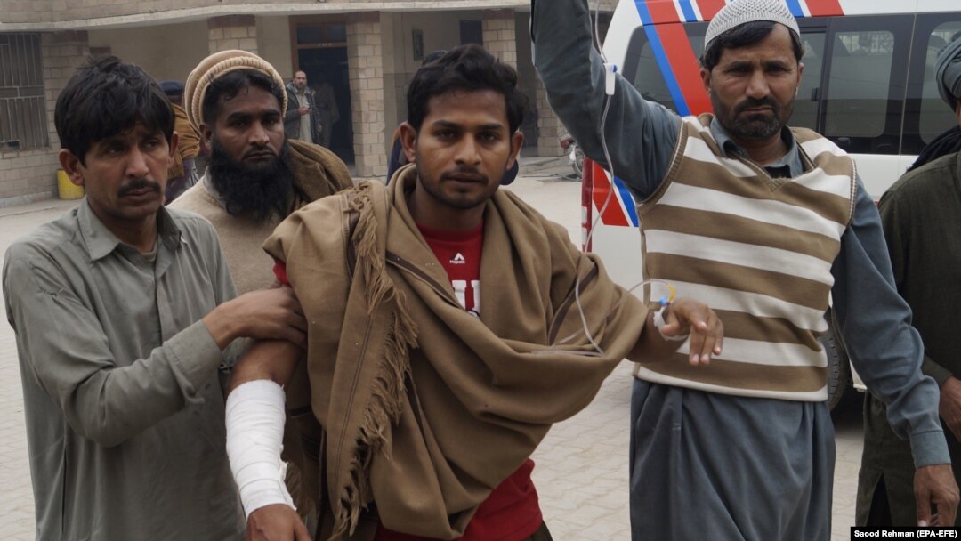 A man, who was injured when unknown gunmen opened fire at a police vehicle, receives medical treatment at a hospital in Dera Ismail Khan on February 12.