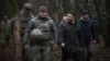 Ukrainian President Volodymyr Zelenskiy (second right) visits a division of the 27th Rocket Artillery Brigade on December 12. 