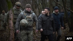 Ukrainian President Volodymyr Zelenskiy (second right) visits a division of the 27th Rocket Artillery Brigade on December 12. 