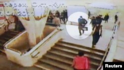 Footage from CCTV cameras shows a person, highlighted as a suspected bomber shortly before last week's explosion at Minsk's Oktyabrskaya subway station 