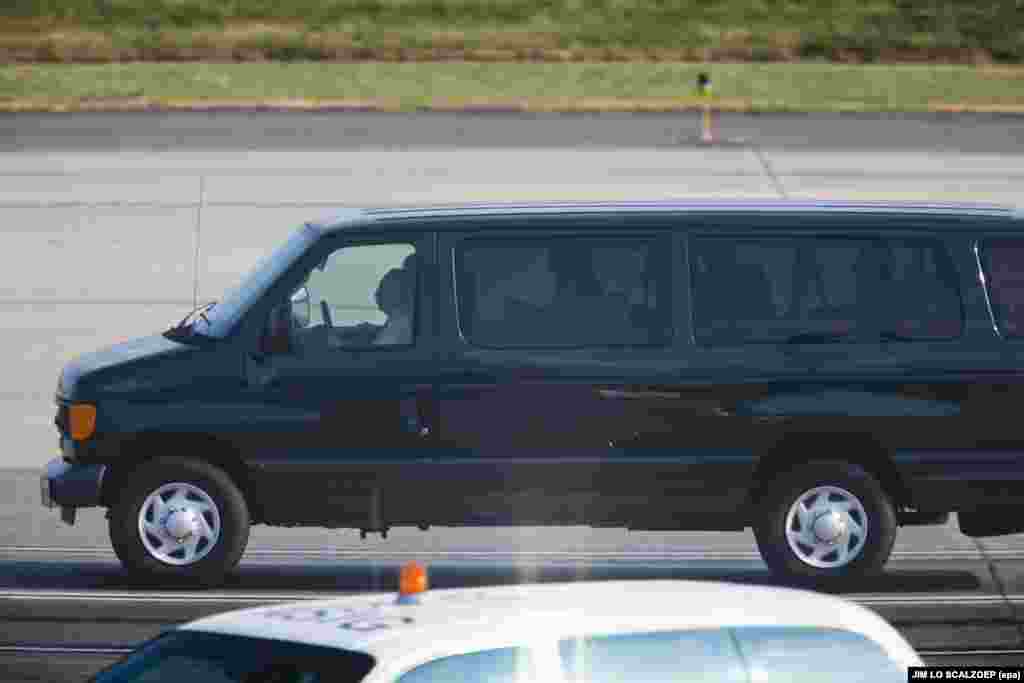 A van containing the four Russian citizens released by Moscow drives off the tarmac at Dulles International Airport on July 9, 2010.