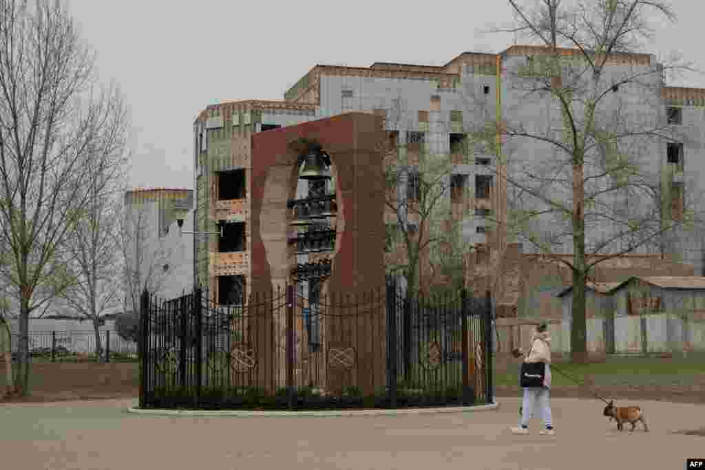 A woman walks through the Heroes of Chernobyl memorial in Kyiv.