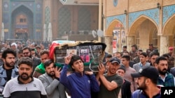 Mourners carry the coffin of Mehdi Kadim, 17, a protester killed during anti-government demonstrations, during his funeral in Najaf, Iraq, Friday, Nov. 29, 2019.(AP Photo/Anmar Khalil)