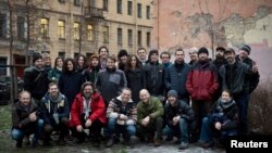 Twenty-six of the Arctic 30 (24 Greenpeace International activists and two freelance journalists) pose in St. Petersburg after their release on bail.